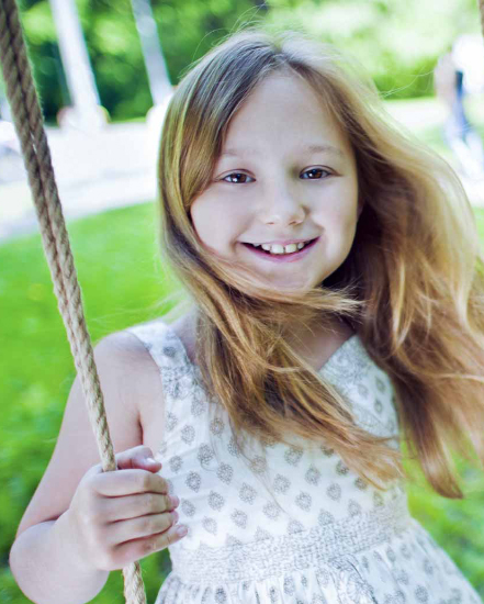 Child Smiling on swings